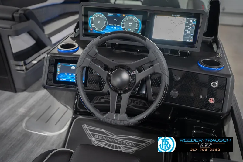 Slide: The Image of 2026 Bennington 24 MSL boat dashboard with advanced digital displays and steering wheel. - 37