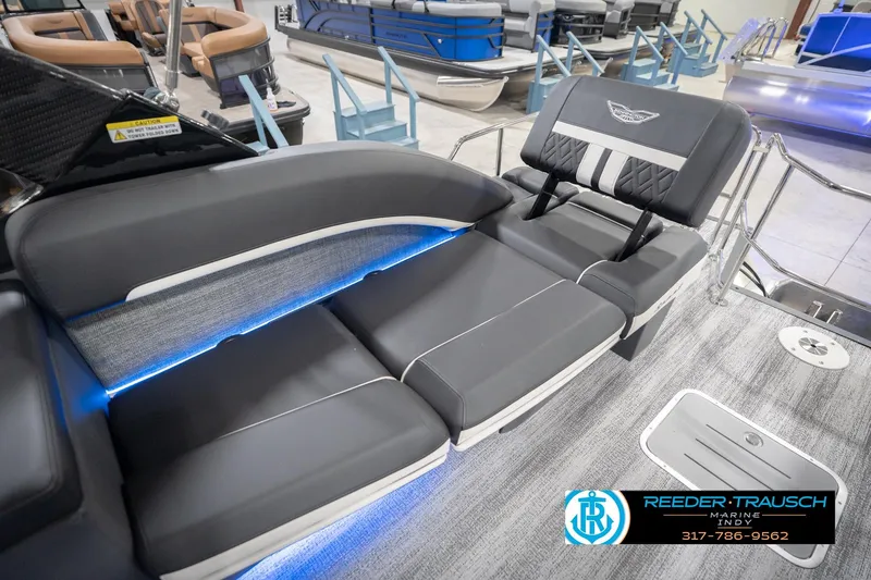 Slide: The Image of 2026 Bennington 24 MSL boat interior with sleek seating and ambient blue lighting. - 48