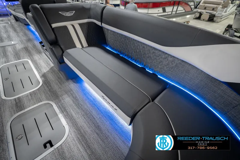 Slide: The Image of 2026 Bennington 24 MSL boat interior with blue LED lighting and sleek seating design. - 49