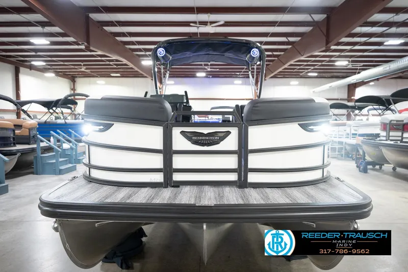Slide: The Image of 2026 Bennington 24 MSL pontoon boat in showroom, front view, with sleek design and modern features. - 5