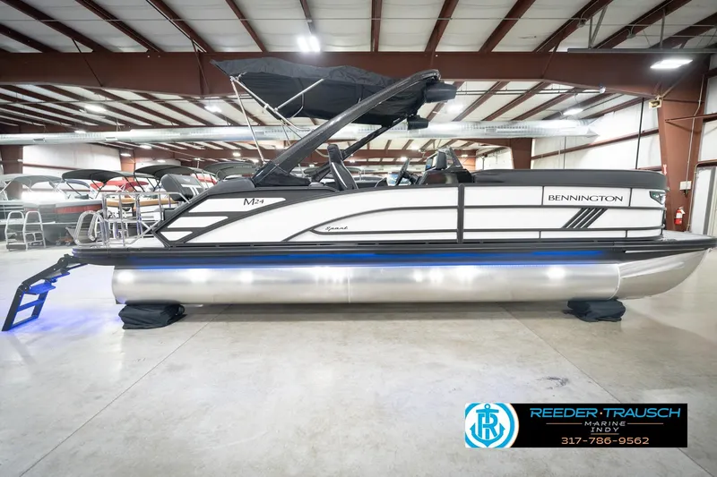 Slide: The Image of 2026 Bennington 24 MSL pontoon boat in showroom, featuring sleek design and modern amenities. - 7