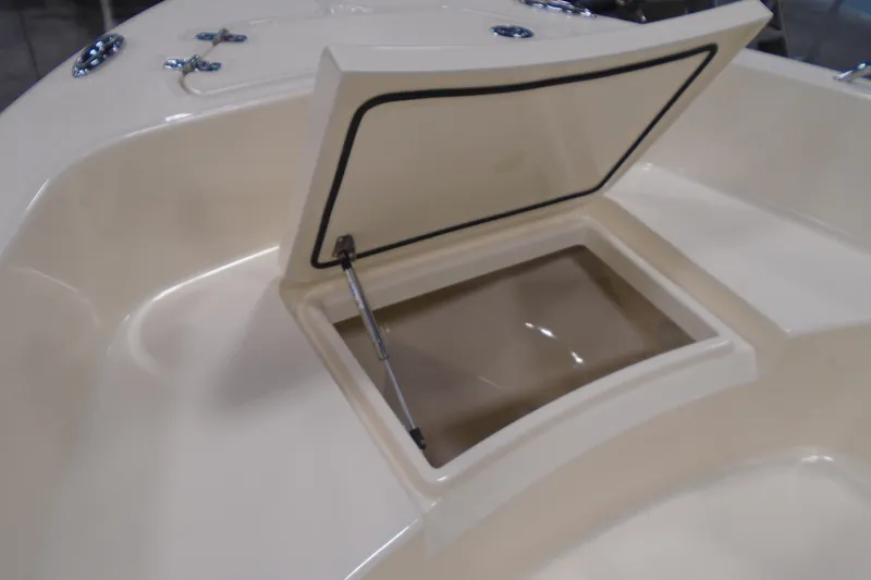 Slide: The Image of Open storage compartment on 2026 Scout 188 Sportfish boat deck. - 12