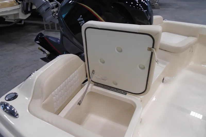 Slide: The Image of 2026 Scout 188 Sportfish boat interior with open storage compartment and Yamaha engine. - 17