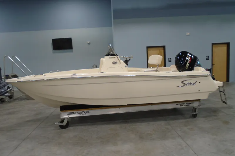 Slide: The Image of 2026 Scout 188 Sportfish boat on trailer in indoor showroom. - 2