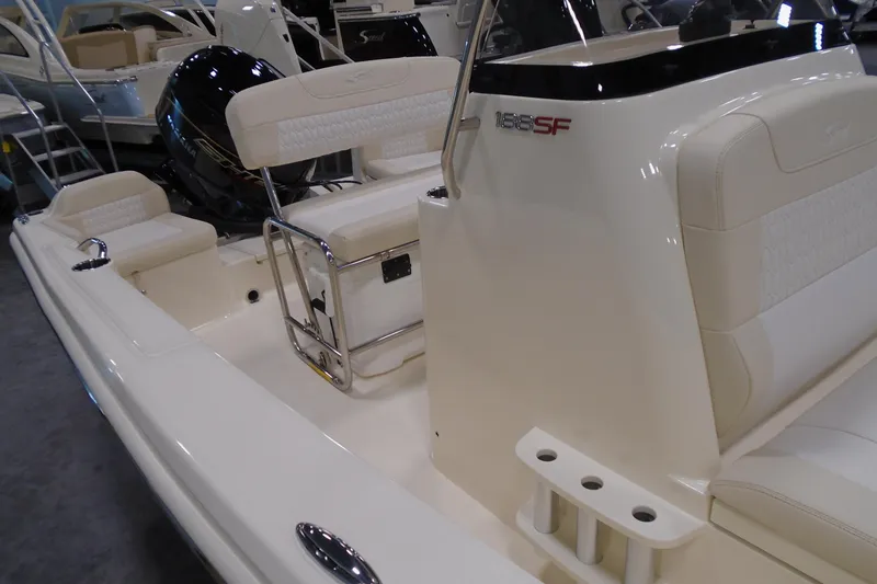 Slide: The Image of 2026 Scout 188 Sportfish boat interior with seating and console, showcasing modern design. - 7