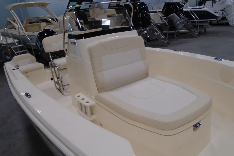 Slide: The Image of 2026 Scout 188 Sportfish boat interior with seating and console, displayed in showroom. - 8