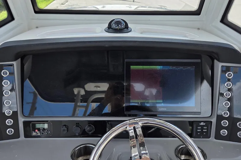 Slide: The Image of 2022 Robalo R272 Center Console dashboard with Garmin display and controls. - 10