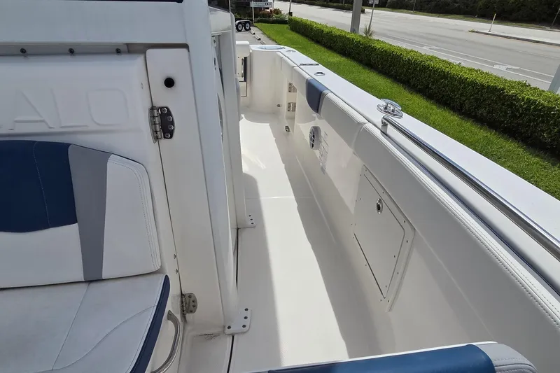 Slide: The Image of 2022 Robalo R272 Center Console boat interior with seating and storage compartments. - 13