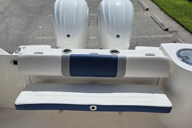 Slide: The Image of 2022 Robalo R272 Center Console boat with dual engines and cushioned seating. - 14