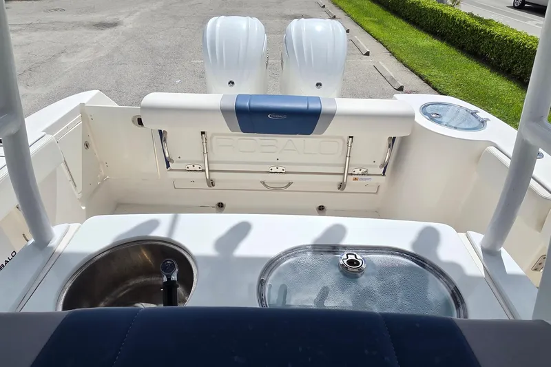 Slide: The Image of 2022 Robalo R272 Center Console boat interior with dual engines and fishing amenities. - 16