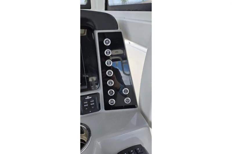 Slide: The Image of 2022 Robalo R272 Center Console dashboard with control panel and buttons. - 17