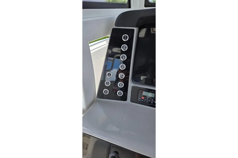 Slide: The Image of 2022 Robalo R272 Center Console dashboard with control panel and buttons. - 18