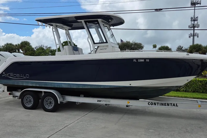 Slide: The Image of 2022 Robalo R272 Center Console boat on trailer, parked outdoors. - 3