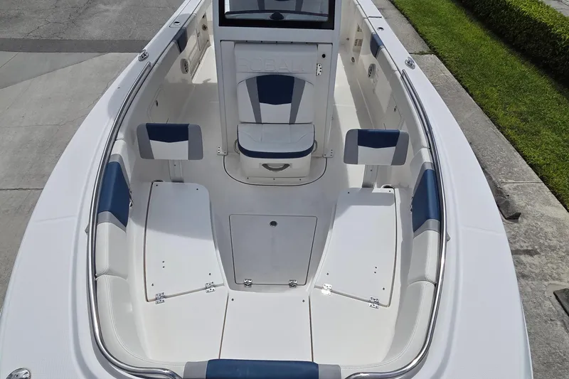 Slide: The Image of 2022 Robalo R272 Center Console boat interior with white and blue seating. - 5