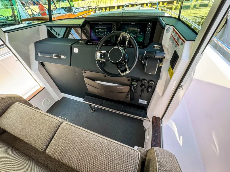 Slide: The Image of 2024 Axopar 37XC CROSS CABIN helm with modern controls and comfortable seating. - 6