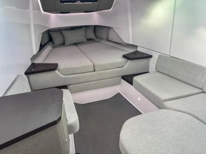 Slide: The Image of 2024 Axopar 37XC CROSS CABIN interior with modern gray seating and cushions. - 12
