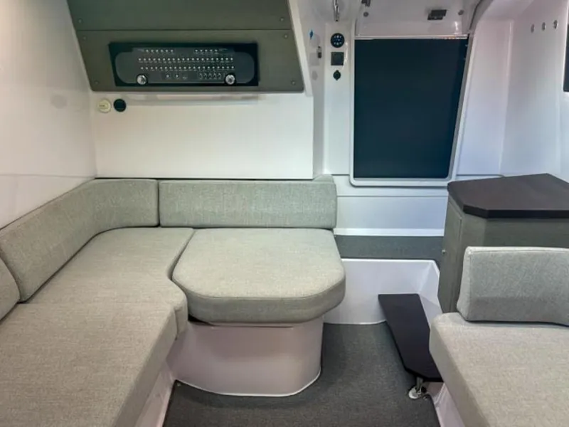 Slide: The Image of 2024 Axopar 37XC CROSS CABIN interior with modern seating and sleek design. - 14