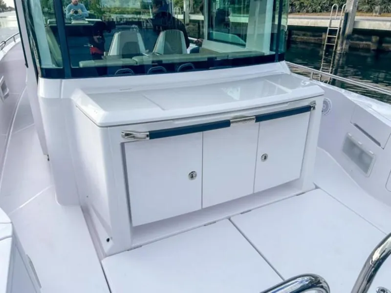 Slide: The Image of 2024 Axopar 37XC CROSS CABIN boat interior with sleek white cabinetry. - 19
