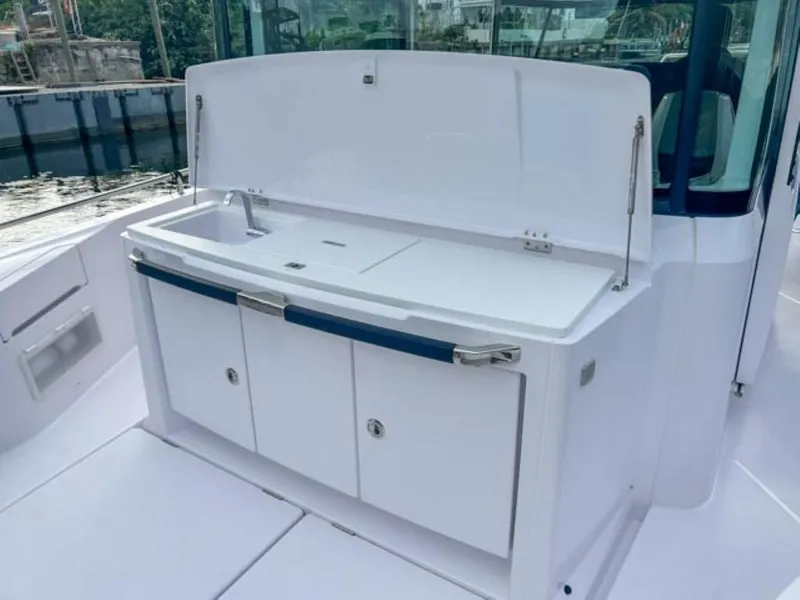 Slide: The Image of 2024 Axopar 37XC CROSS CABIN outdoor kitchen with storage cabinets. - 20