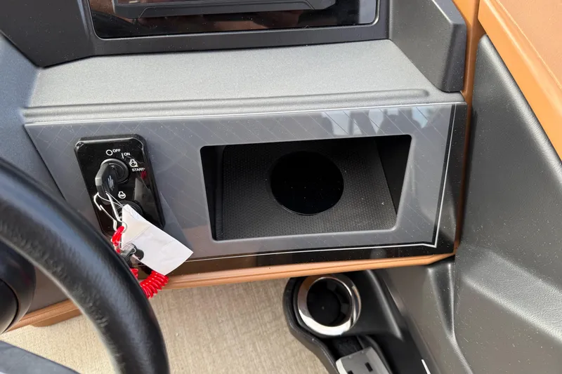 Slide: The Image of Control panel of 2026 Avalon Catalina Entertainer Funship with ignition switch and storage compartment. - 25