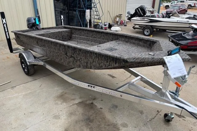 Slide: The Image of 2026 Xpress XTS16 boat on trailer, camo design, parked outdoors. - 1