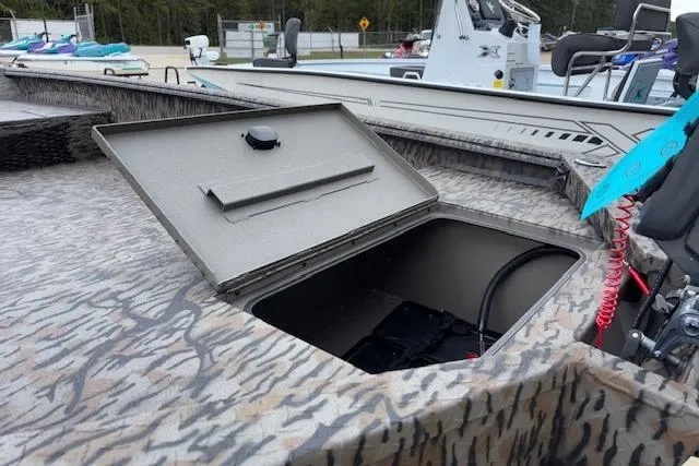 Slide: The Image of Open storage compartment on 2026 Xpress XTS16 boat deck. - 11