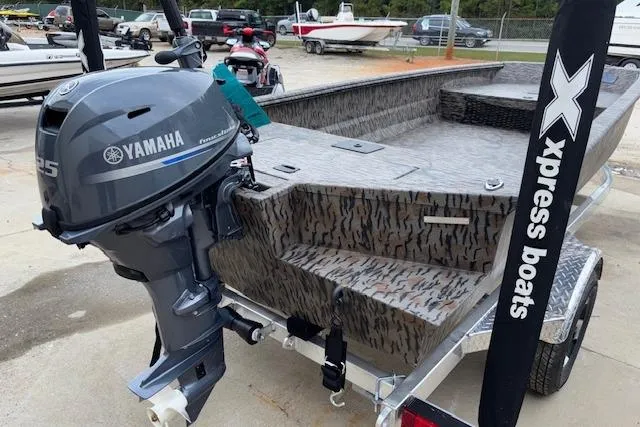 Slide: The Image of 2026 Xpress XTS16 boat with Yamaha motor, camo design, on trailer. - 4