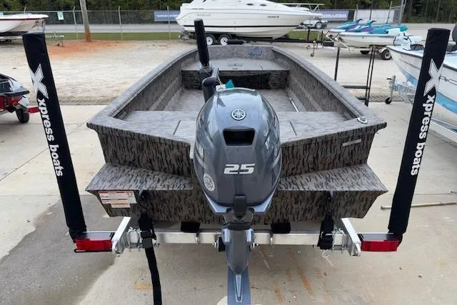 Slide: The Image of 2026 Xpress XTS16 boat with 25HP motor, parked on trailer at marina. - 5