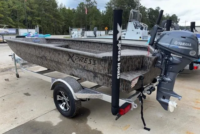 Slide: The Image of 2026 Xpress XTS16 boat with Yamaha motor on a trailer, parked outdoors. - 6