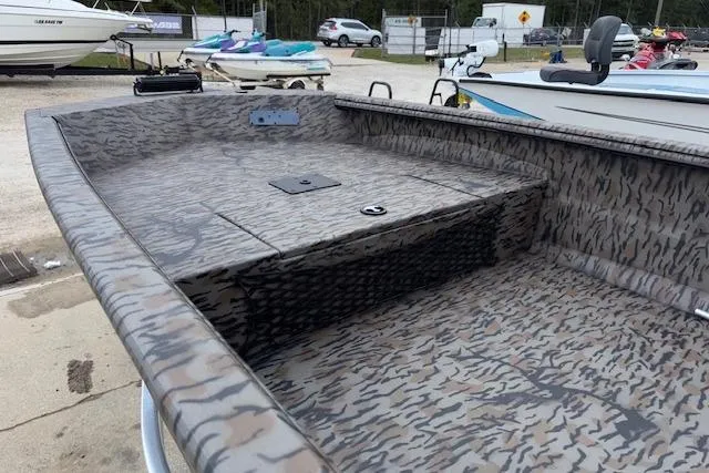 Slide: The Image of 2026 Xpress XTS16 boat with camouflage pattern, docked outdoors. - 9