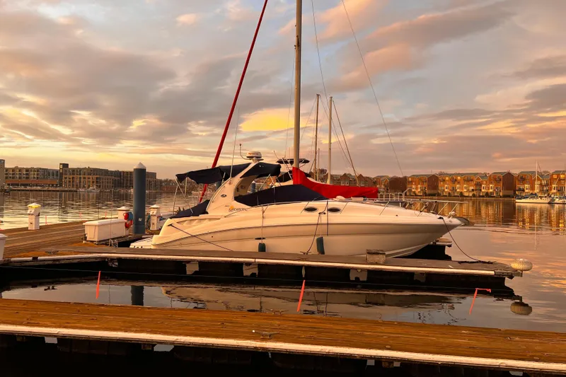 The Image of 2006 Sea Ray 320 Sundancer docked at sunset, reflecting on calm waters. - 0