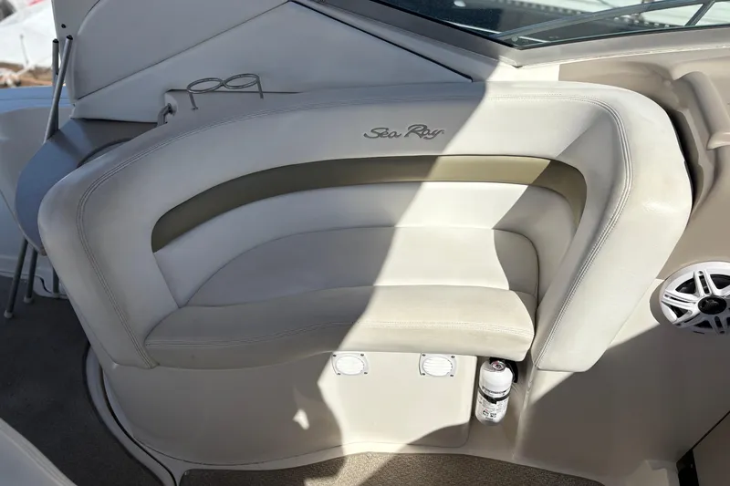 Slide: The Image of 2006 Sea Ray 320 Sundancer boat interior with cushioned seating and speaker. - 12