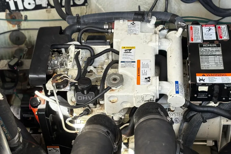 Slide: The Image of Engine compartment of a 2006 Sea Ray 320 Sundancer with visible Kohler generator. - 18