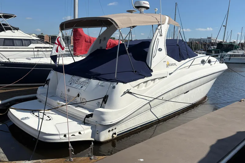Slide: The Image of 2006 Sea Ray 320 Sundancer docked at marina, covered with navy blue canvas. - 5