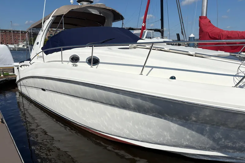 Slide: The Image of 2006 Sea Ray 320 Sundancer docked at marina, sunny day, sleek white design. - 6