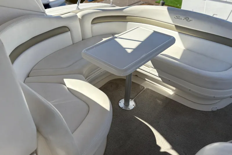 Slide: The Image of 2006 Sea Ray 320 Sundancer interior with white seating and table. - 8