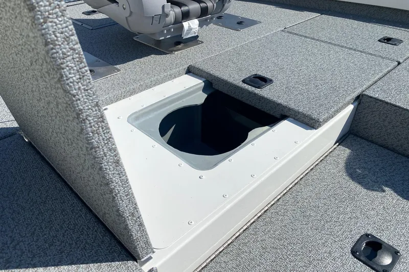 Slide: The Image of 2026 G3 Sportsman 1710PFX boat with open storage compartment on deck. - 10