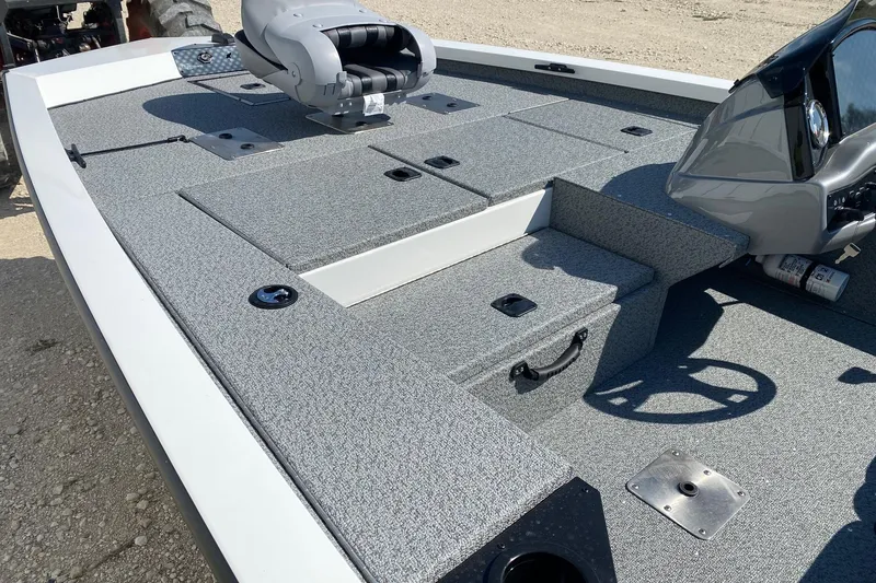 Slide: The Image of 2026 G3 Sportsman 1710PFX boat deck with seating and steering wheel, featuring gray carpeting. - 11