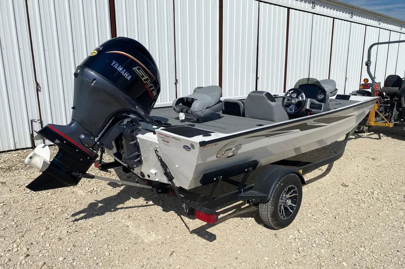 Slide: The Image of 2026 G3 Sportsman 1710PFX boat with Yamaha outboard motor, parked on a trailer. - 5