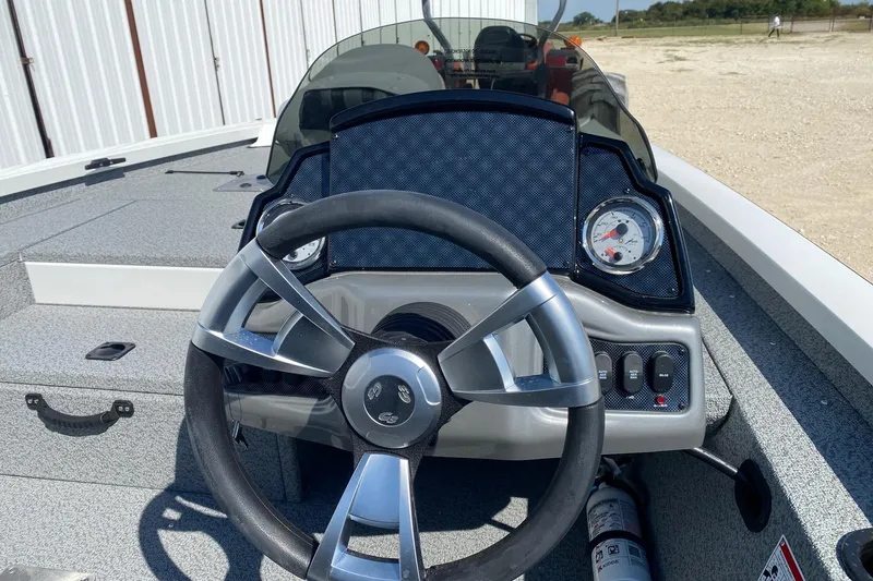 Slide: The Image of 2026 G3 Sportsman 1710PFX boat dashboard with steering wheel and gauges. - 6