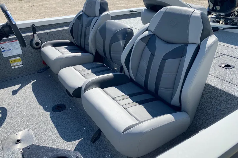Slide: The Image of 2026 G3 Sportsman 1710PFX boat interior with gray and black cushioned seats. - 8