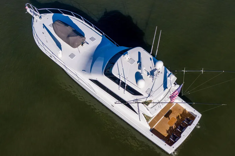 Slide: The Image of Aerial view of 2002 Viking 65 Enclosed Bridge yacht on calm water. - 15