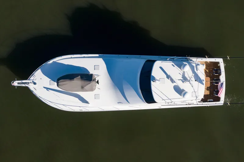 Slide: The Image of Top view of 2002 Viking 65 Enclosed Bridge yacht on calm water. - 16