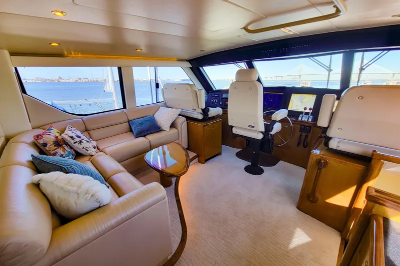 Slide: The Image of Luxurious interior of 2002 Viking 65 Enclosed Bridge yacht with plush seating and helm. - 25