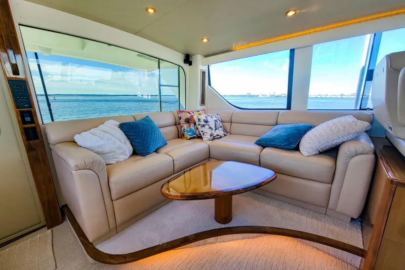 Slide: The Image of Luxurious interior of 2002 Viking 65 Enclosed Bridge yacht with plush seating and ocean view. - 27
