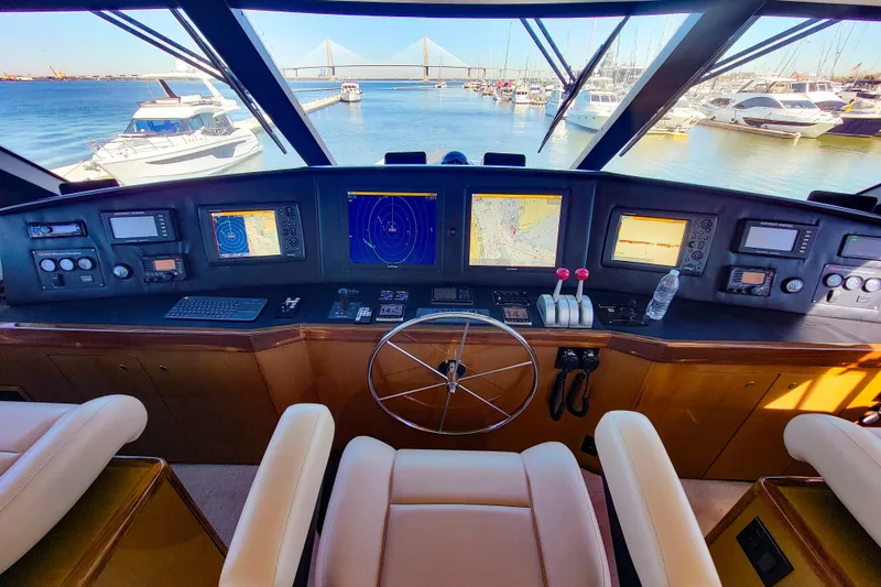 Slide: The Image of Interior view of 2002 Viking 65 Enclosed Bridge yacht helm with navigation equipment. - 28