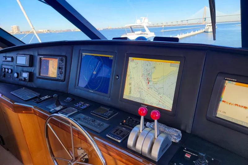 Slide: The Image of Bridge of 2002 Viking 65 Enclosed Bridge yacht with navigation screens and controls. - 32