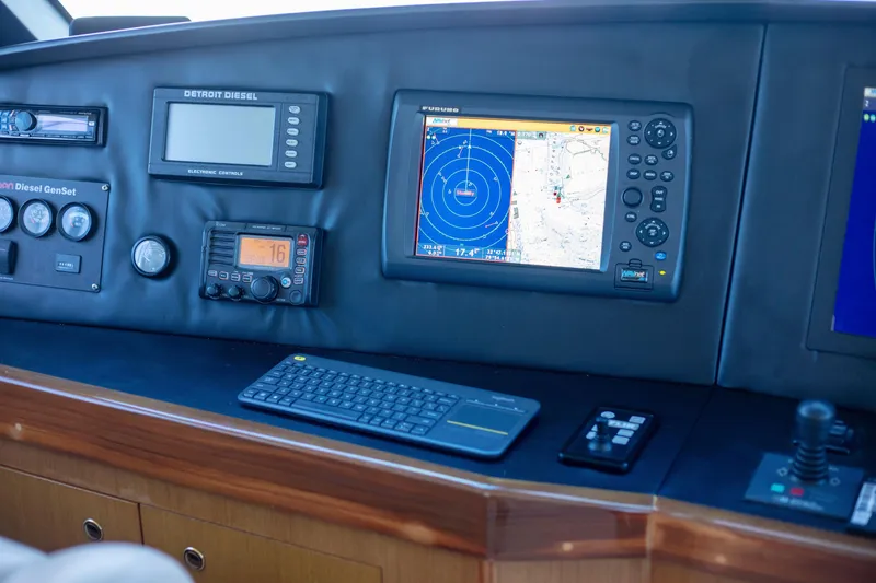 Slide: The Image of Control panel of 2002 Viking 65 Enclosed Bridge yacht with navigation and communication equipment. - 42
