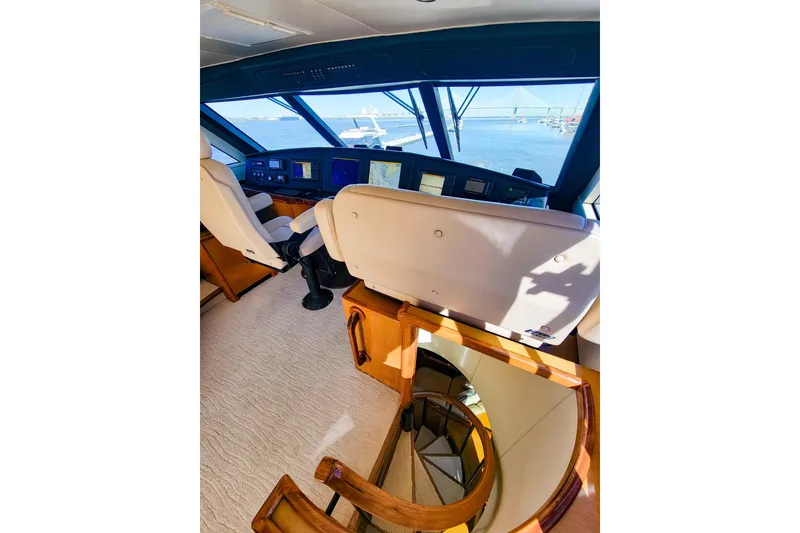 Slide: The Image of Interior view of 2002 Viking 65 Enclosed Bridge yacht helm with navigation screens. - 49