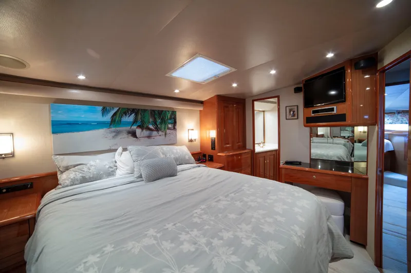 Slide: The Image of Luxurious bedroom interior of 2002 Viking 65 Enclosed Bridge yacht with beach-themed decor. - 68
